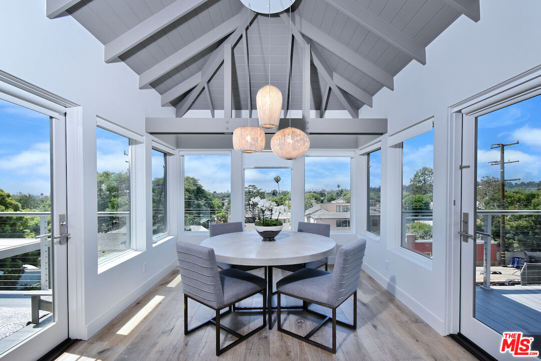 a view of a dining room with furniture wooden floor and a chandelier