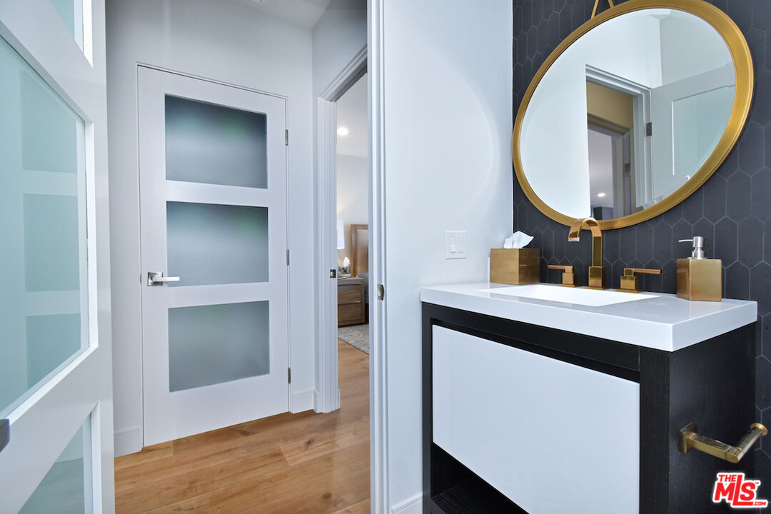 922 Berkeley Street Santa Monica, CA 90403 - Photo 11 of 33 a bathroom with a sink a mirror and a vanity