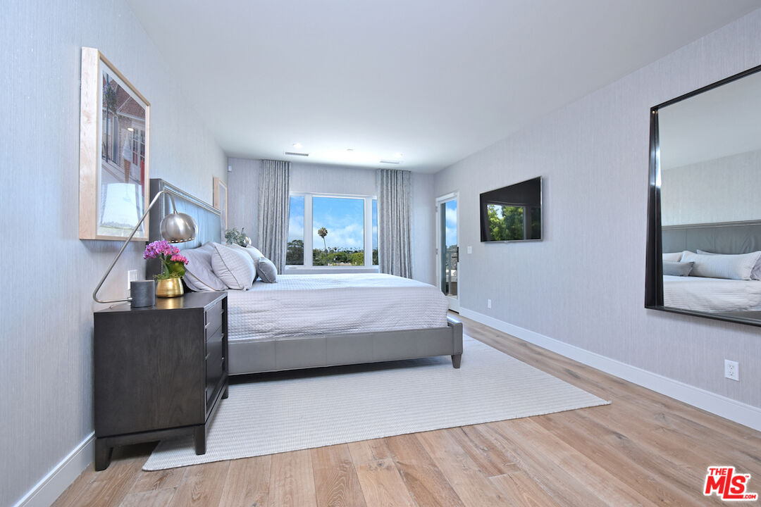 922 Berkeley Street Santa Monica, CA 90403 - Photo 16 of 33 a bedroom with a bed and a flat screen tv