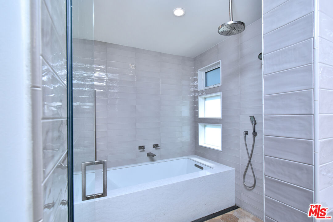 922 Berkeley Street Santa Monica, CA 90403 - Photo 18 of 33 a bathroom with a tub shower vanity and a sink