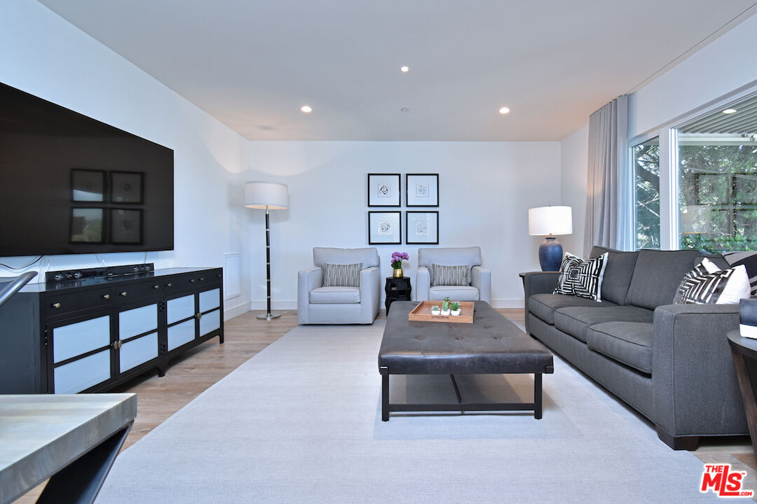 922 Berkeley Street Santa Monica, CA 90403 - Photo 21 of 33 a living room with furniture and a flat screen tv