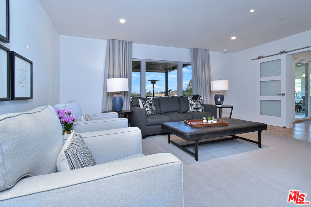 922 Berkeley Street Santa Monica, CA 90403 - Photo 22 of 33 a living room with furniture and a potted plant