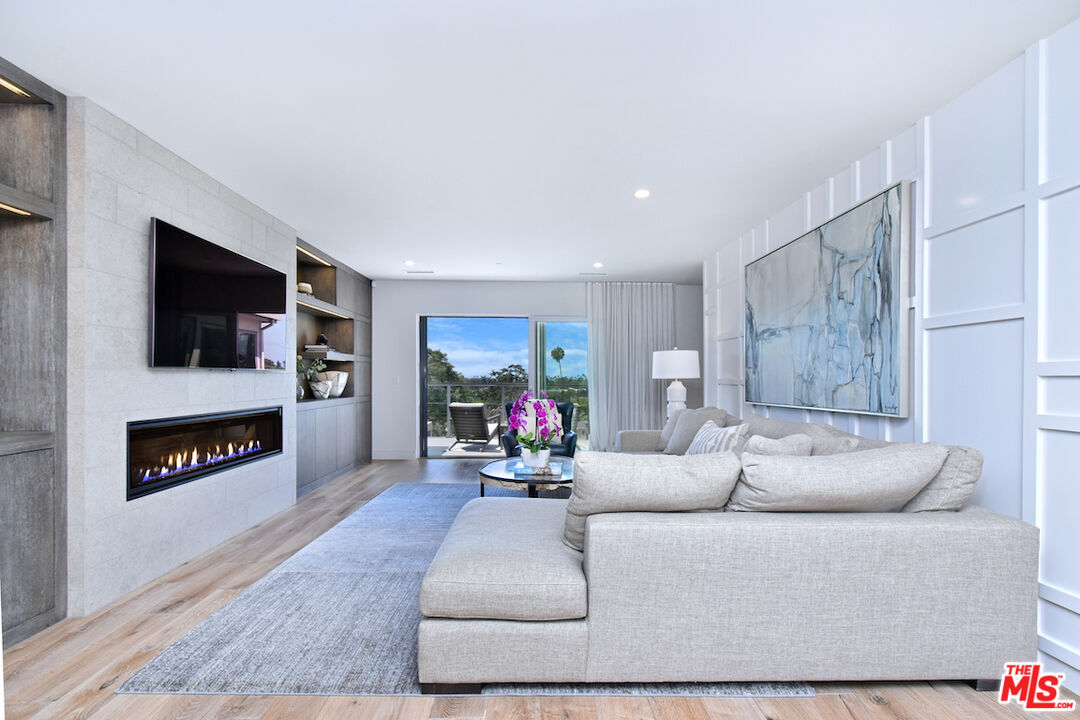 922 Berkeley Street Santa Monica, CA 90403 - Photo 4 of 33 a living room with furniture and a flat screen tv