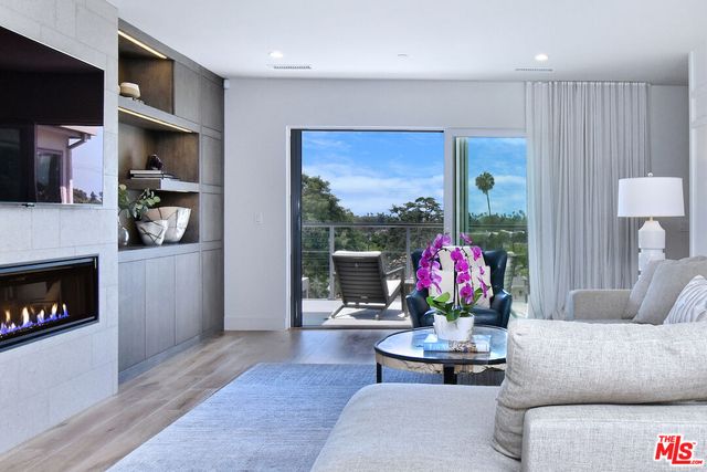 a living room with furniture fireplace and flat screen tv