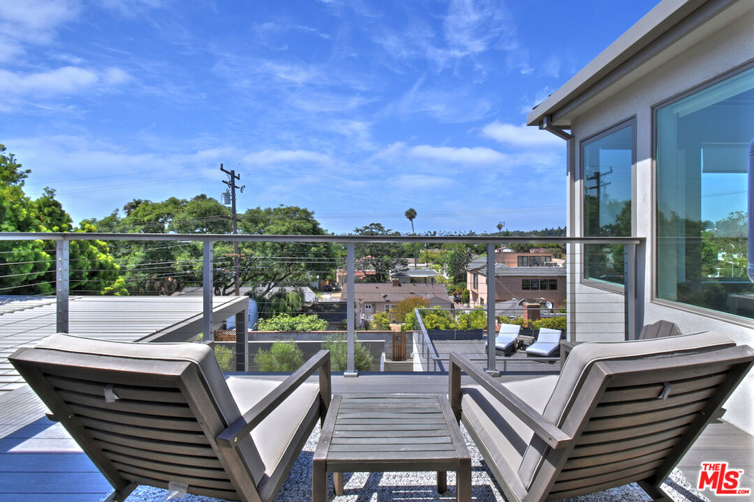 922 Berkeley Street Santa Monica, CA 90403 - Photo 6 of 33 a view of a balcony with two chairs and a potted plant