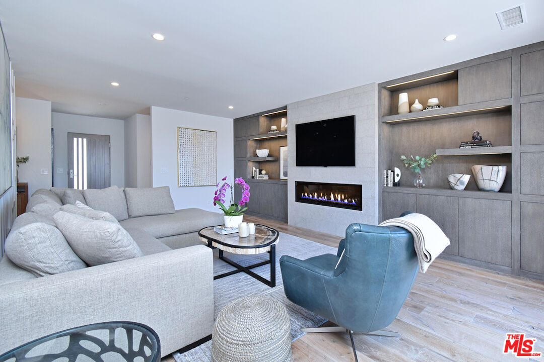 922 Berkeley Street Santa Monica, CA 90403 - Photo 7 of 33 a living room with fireplace furniture and a flat screen tv