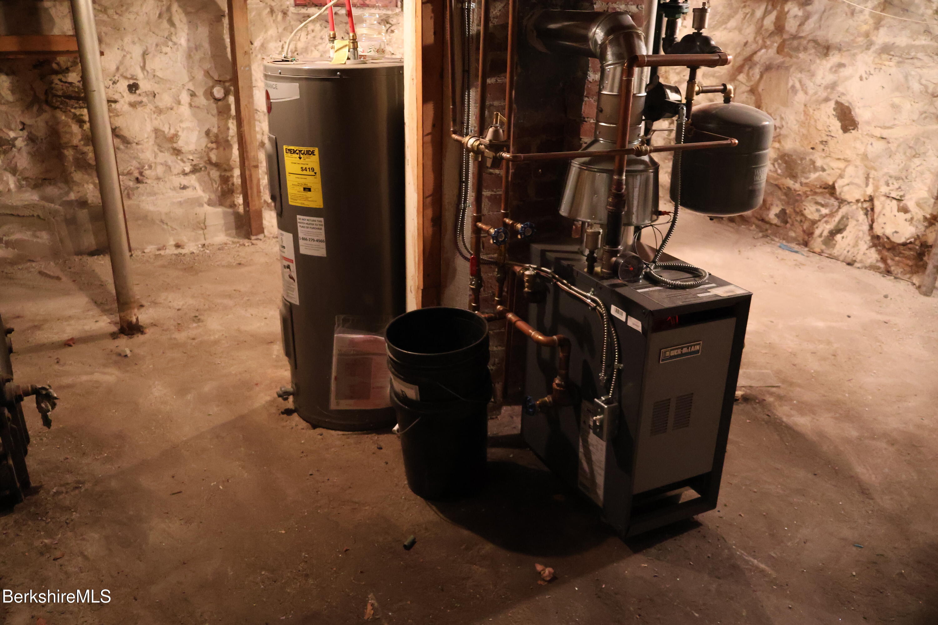 89 Columbia Street Adams, MA 01220 - Photo 14 of 14 a room with water heater and wooden walls