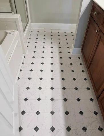 a bathroom with a black white checkered floor