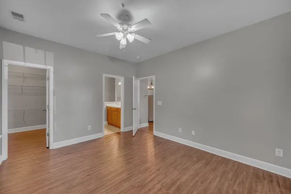 a view of an empty room with wooden floor