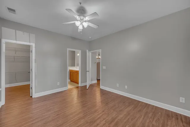 a view of an empty room with wooden floor