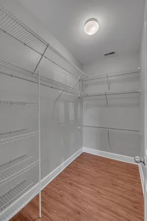 a view of a room with wooden floor