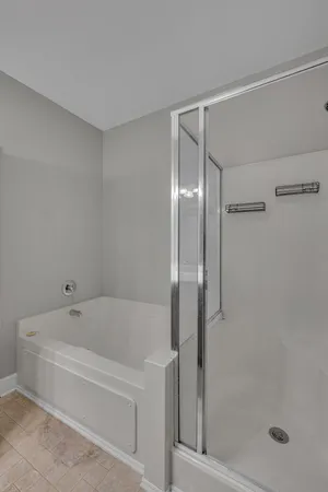 a white bath tub sitting next to a shower
