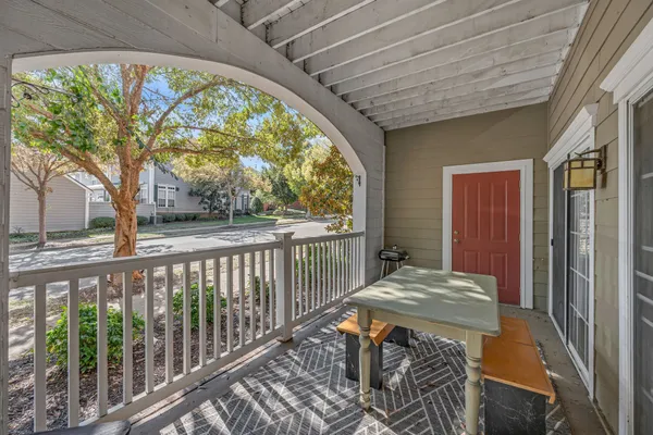 a balcony view with a large window and wooden floor