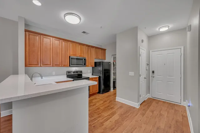 a kitchen with stainless steel appliances granite countertop a sink refrigerator stove microwave and cabinets