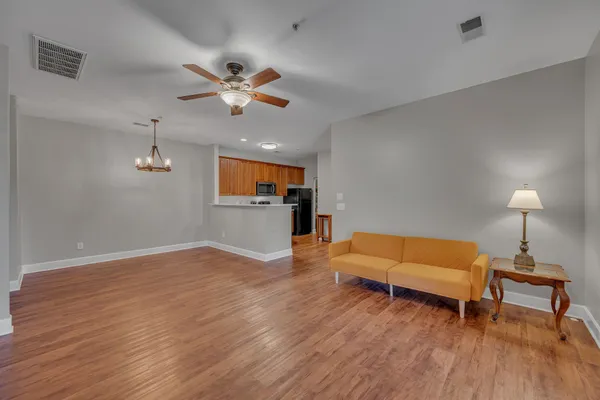 a living room with furniture and a wooden floor