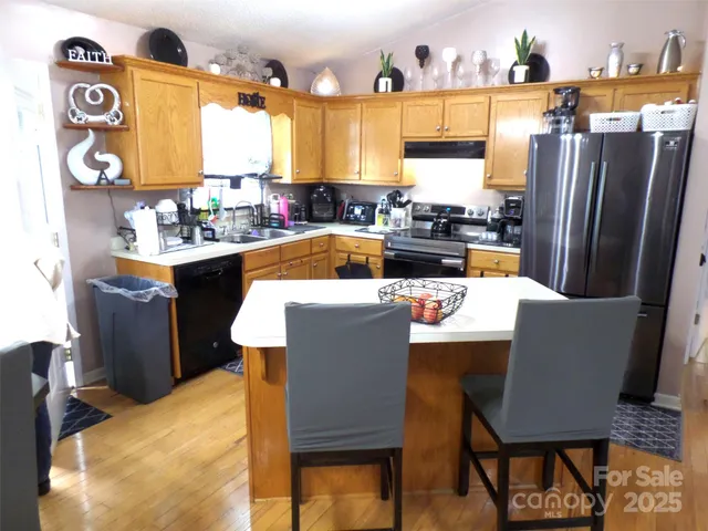 a kitchen with a table chairs and a refrigerator