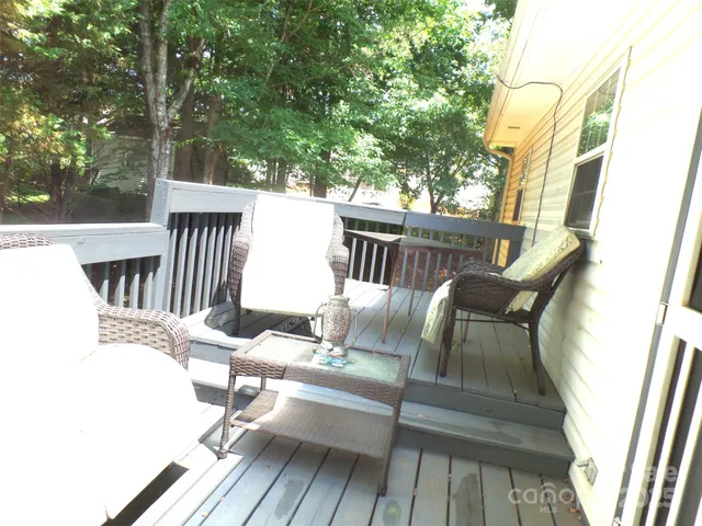 a view of balcony with wooden floor and outdoor seating
