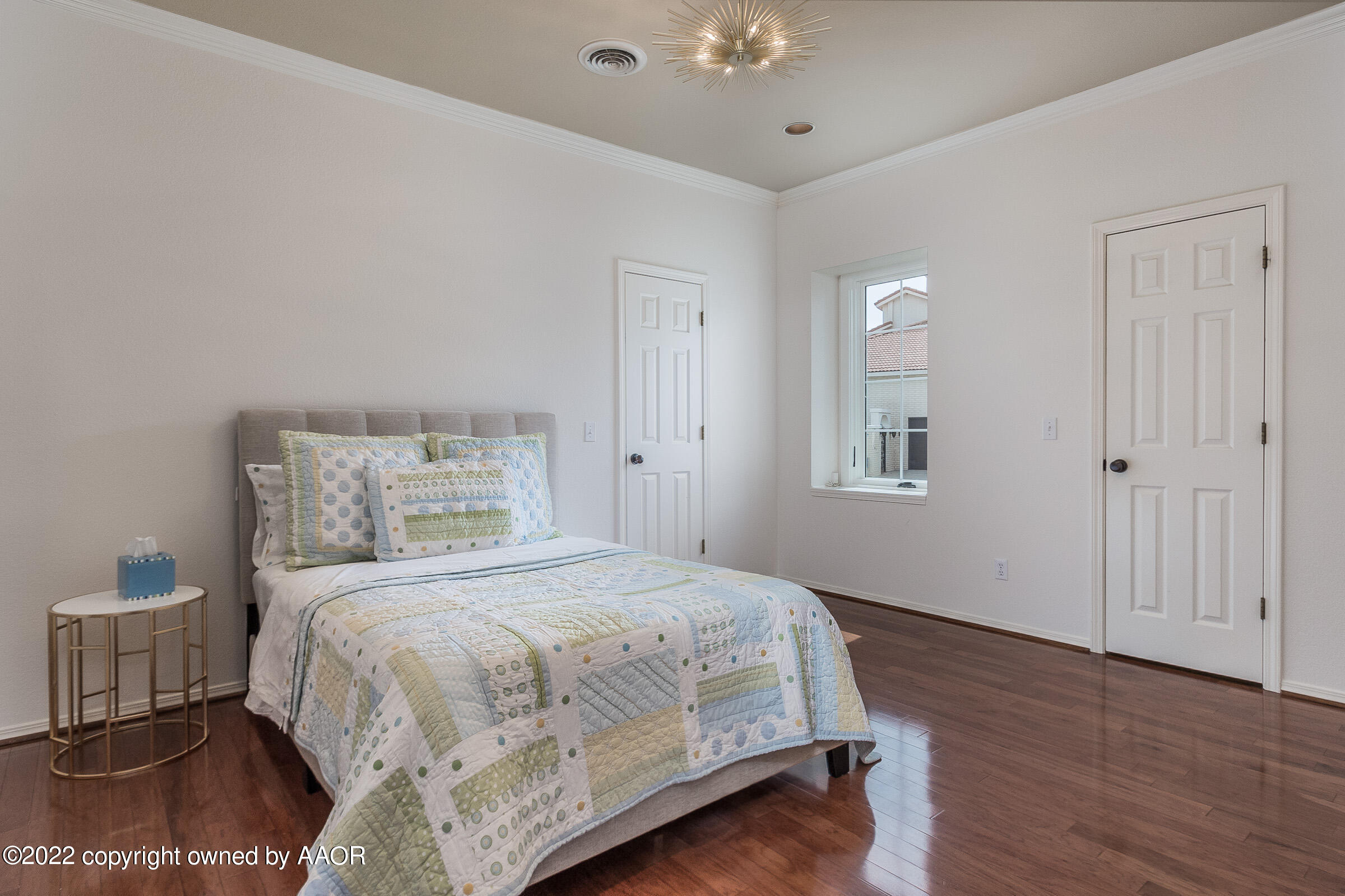 2 Snead Lane Amarillo, TX 79124 - Photo 35 of 76 a bedroom with a large bed and a chandelier