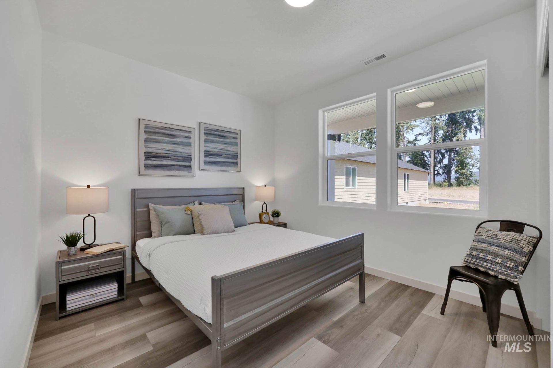 3305 East Fitz Roy Street Kuna, ID 83634 - Photo 15 of 23 Bedroom featuring light wood-type flooring and baseboards