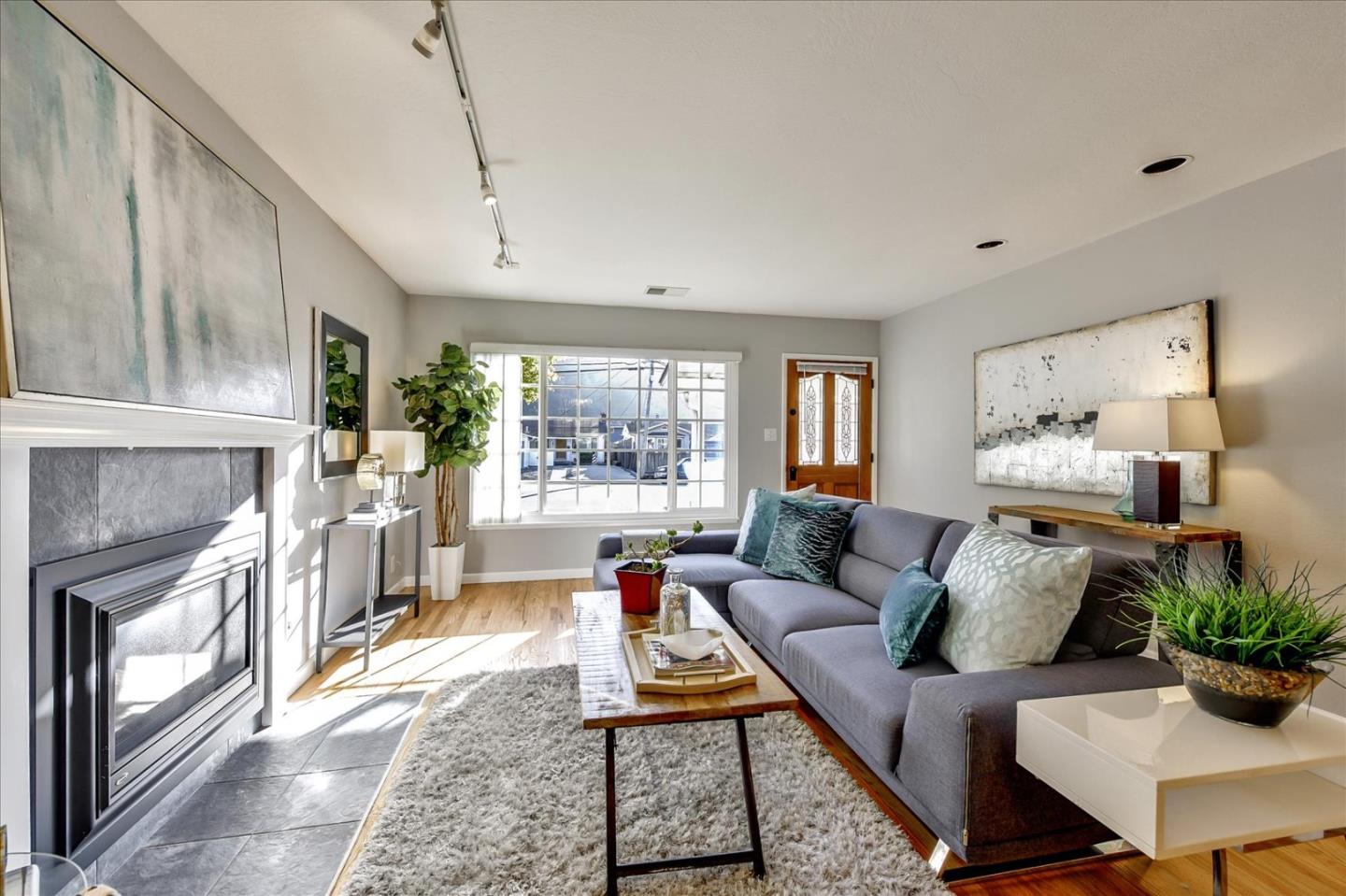 a living room with furniture and a fireplace