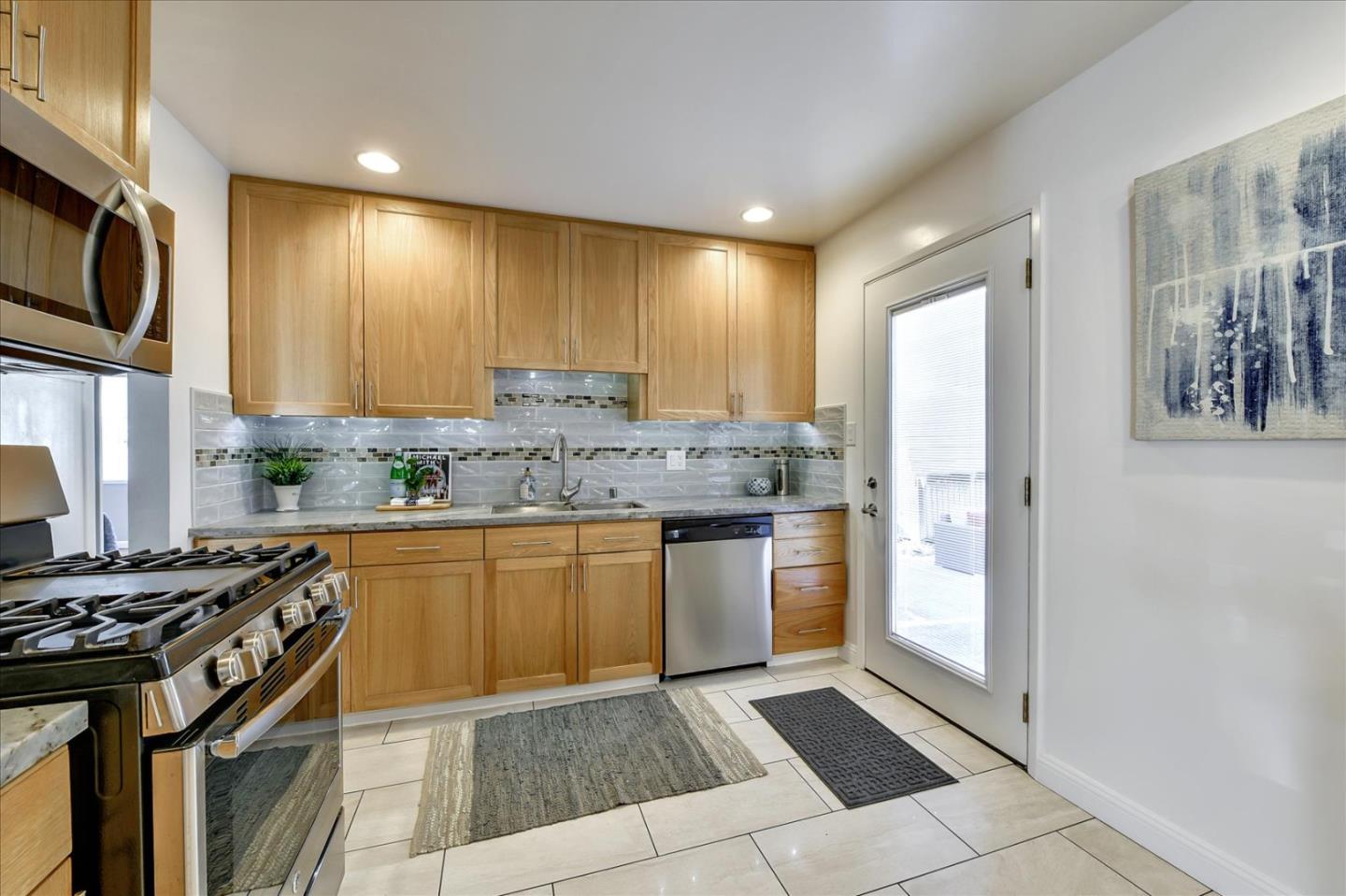 1371 Linda Mar Boulevard Pacifica, CA 94044 - Photo 12 of 30 a kitchen with stainless steel appliances granite countertop a stove a sink and a refrigerator