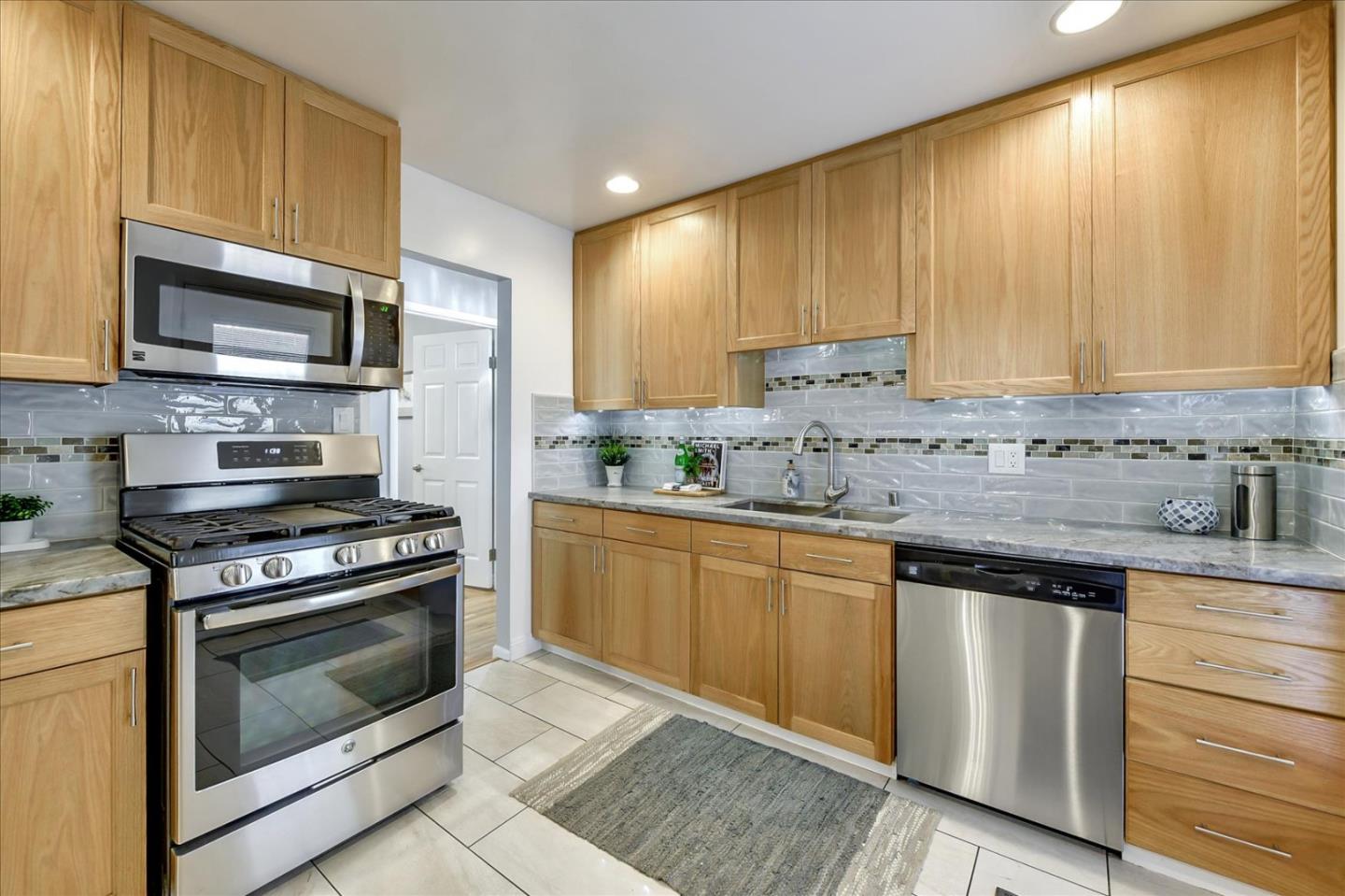 1371 Linda Mar Boulevard Pacifica, CA 94044 - Photo 14 of 30 a kitchen with stainless steel appliances granite countertop a stove a sink and a microwave