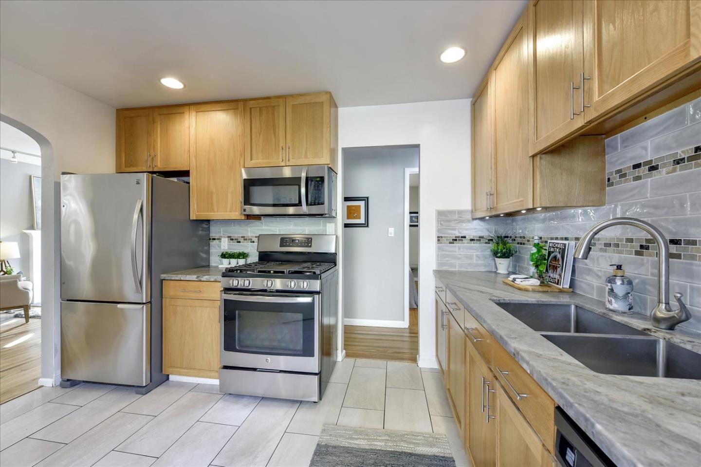 1371 Linda Mar Boulevard Pacifica, CA 94044 - Photo 15 of 30 a kitchen with stainless steel appliances granite countertop a refrigerator sink and stove