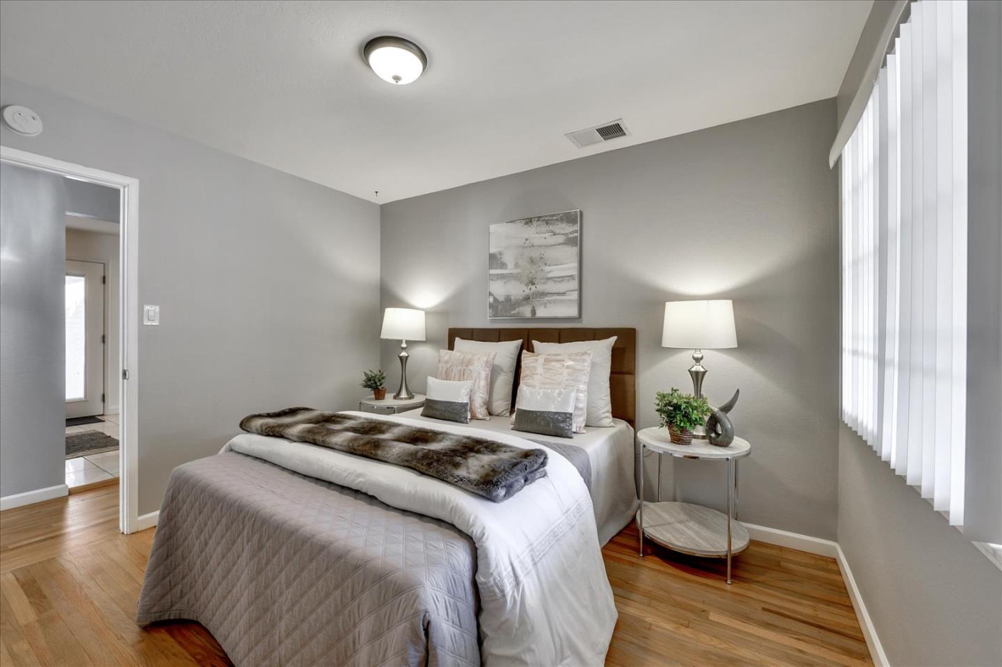 1371 Linda Mar Boulevard Pacifica, CA 94044 - Photo 19 of 30 a bedroom with a bed and wooden floor