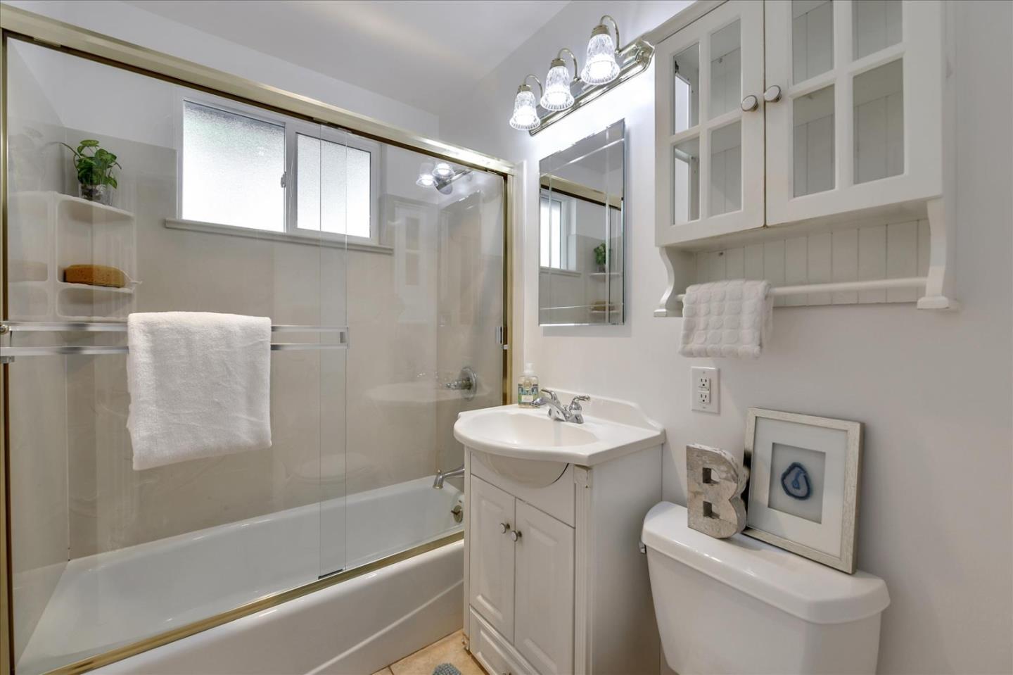 1371 Linda Mar Boulevard Pacifica, CA 94044 - Photo 23 of 30 a bathroom with a sink a toilet and shower