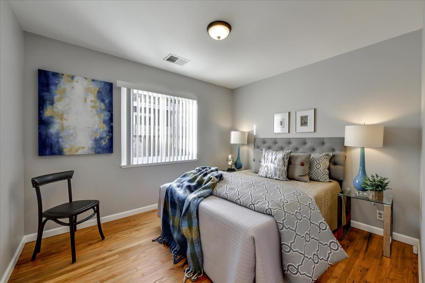 1371 Linda Mar Boulevard Pacifica, CA 94044 - Photo 24 of 30 a bedroom with a bed and wooden floor