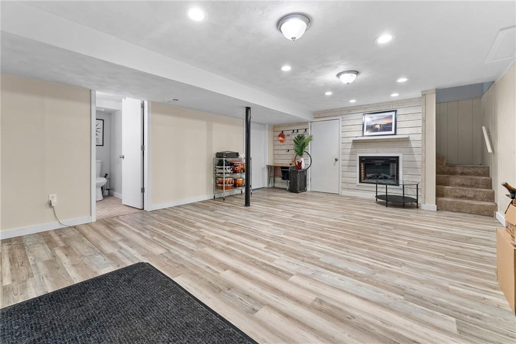 400 Pearce Road Pittsburgh, PA 15234 - Photo 23 of 31 an empty room with wooden floor and fireplace