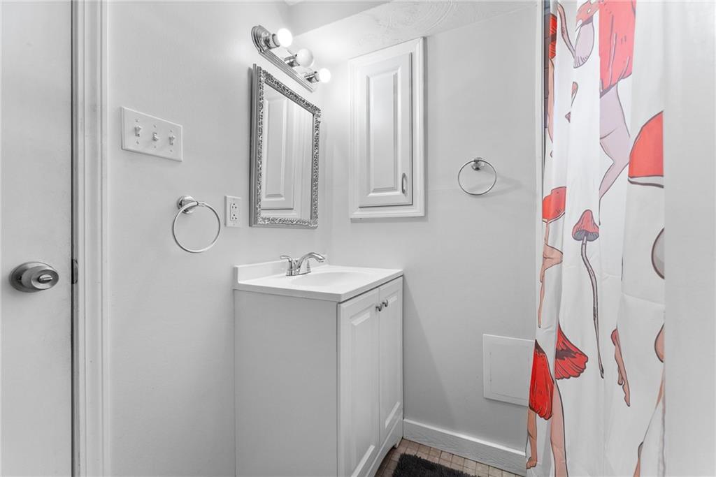 400 Pearce Road Pittsburgh, PA 15234 - Photo 25 of 31 a bathroom with a sink vanity and mirror