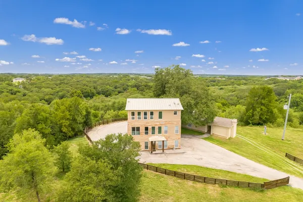 a view of a big building with big trees
