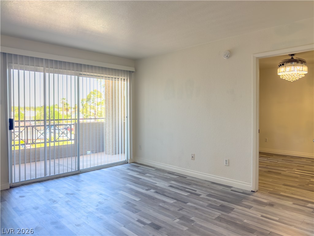 8070 West Russell Road, Unit 2063 Las Vegas, NV 89113 - Photo 2 of 9 Step into a generously proportioned living space featuring an adjoining balcony and durable flooring.