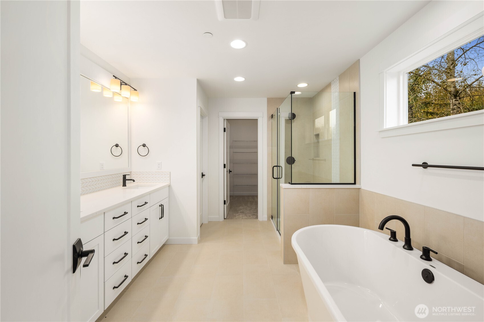 722 211th Place Southeast Bothell, WA 98021 - Photo 18 of 27 a bathroom with a double vanity sink a large mirror a shower and bathtub