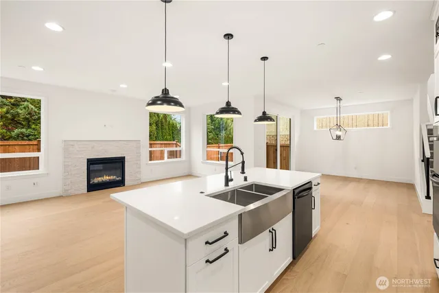 a hallway with white cabinets and wooden floor