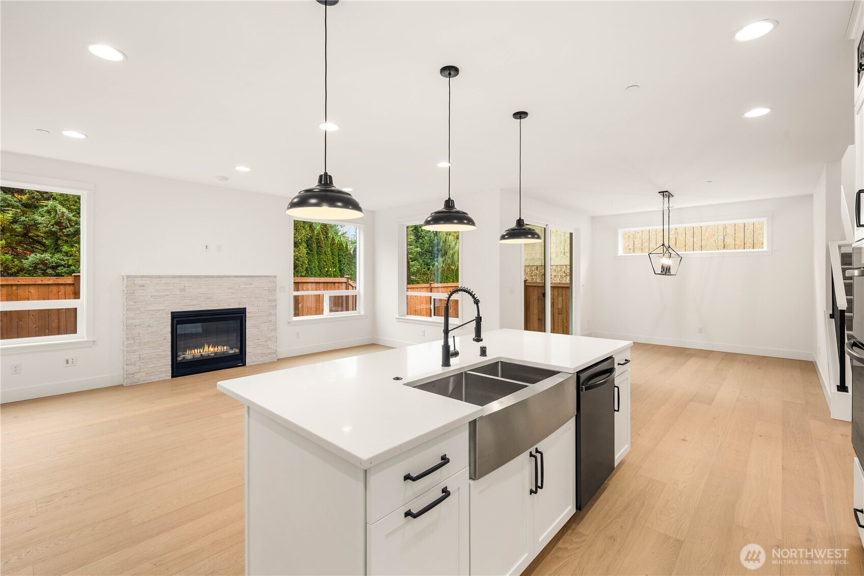 722 211th Place Southeast Bothell, WA 98021 - Photo 6 of 27 a kitchen with stainless steel appliances granite countertop a sink a stove and a wooden floors