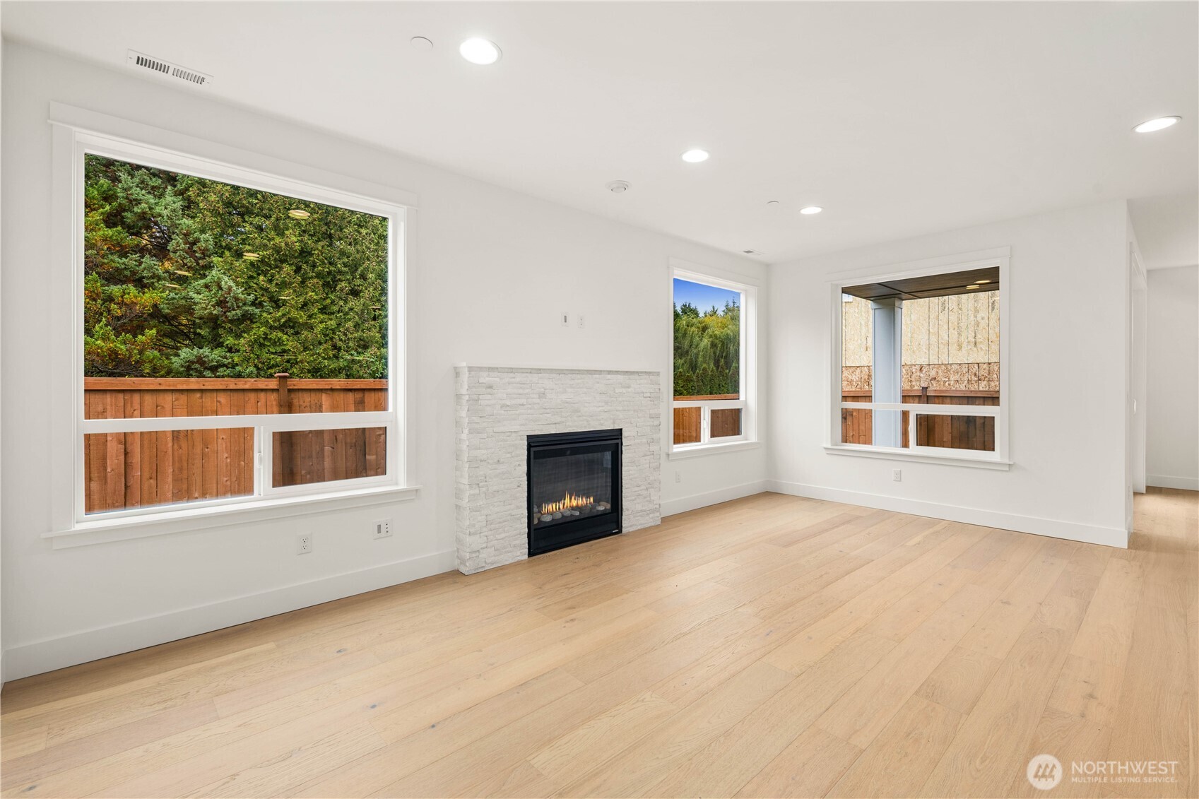 722 211th Place Southeast Bothell, WA 98021 - Photo 9 of 27 an empty room with windows and fireplace