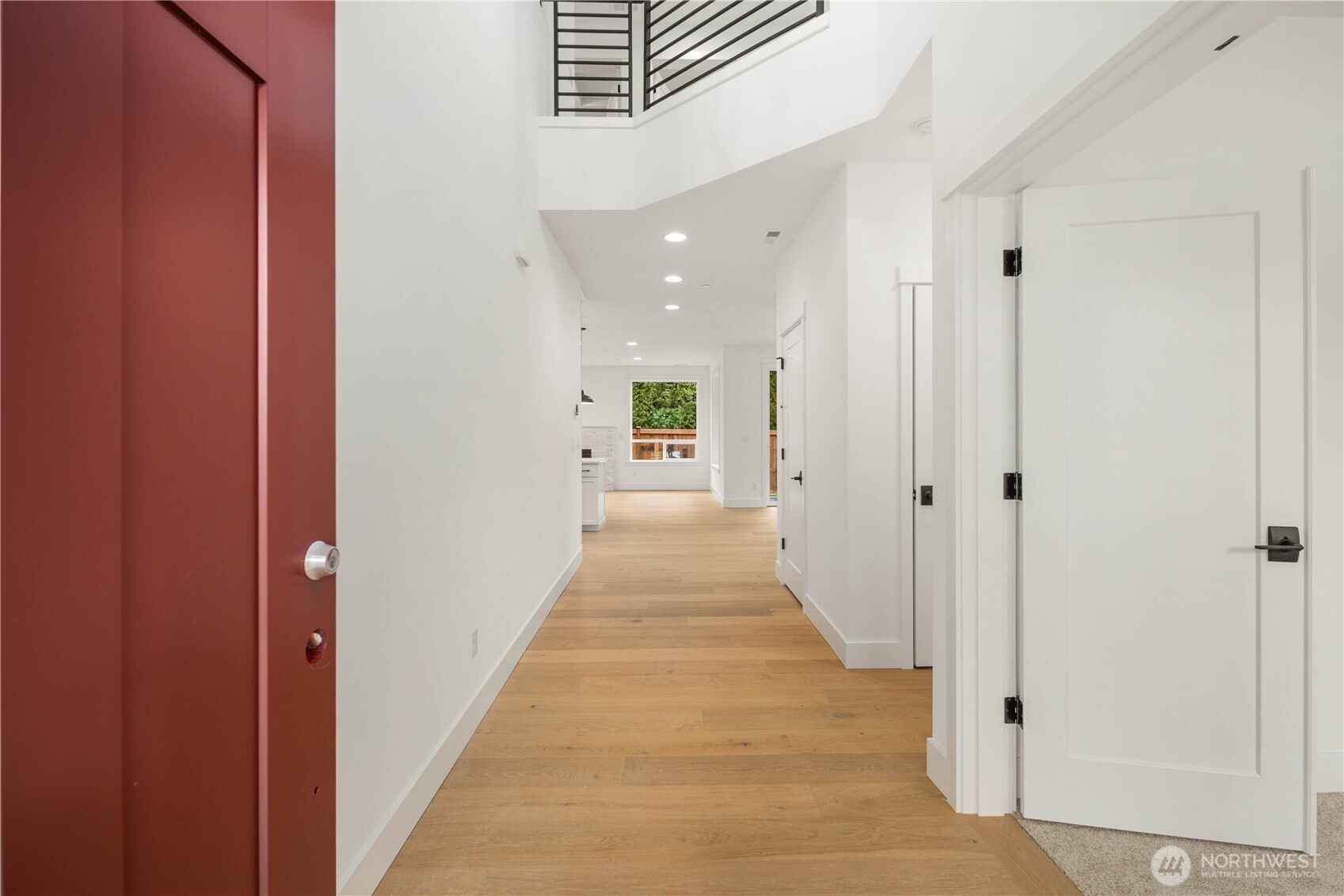 722 211th Place Southeast Bothell, WA 98021 - Photo 10 of 27 a view of a hallway with wooden floor and a bathroom