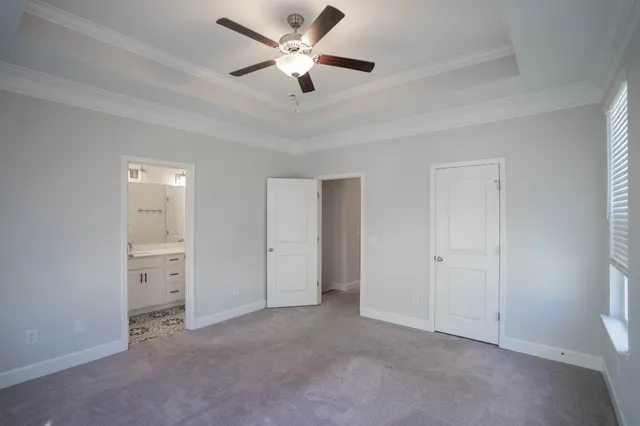 a view of a big room with chandelier fan