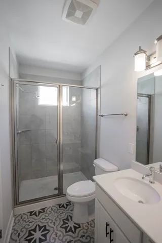 a bathroom with a sink toilet and shower