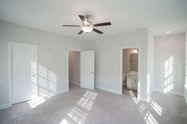 a view of a livingroom with a ceiling fan and window