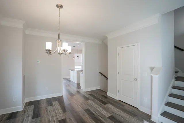 a view of a room with wooden floor and staircase