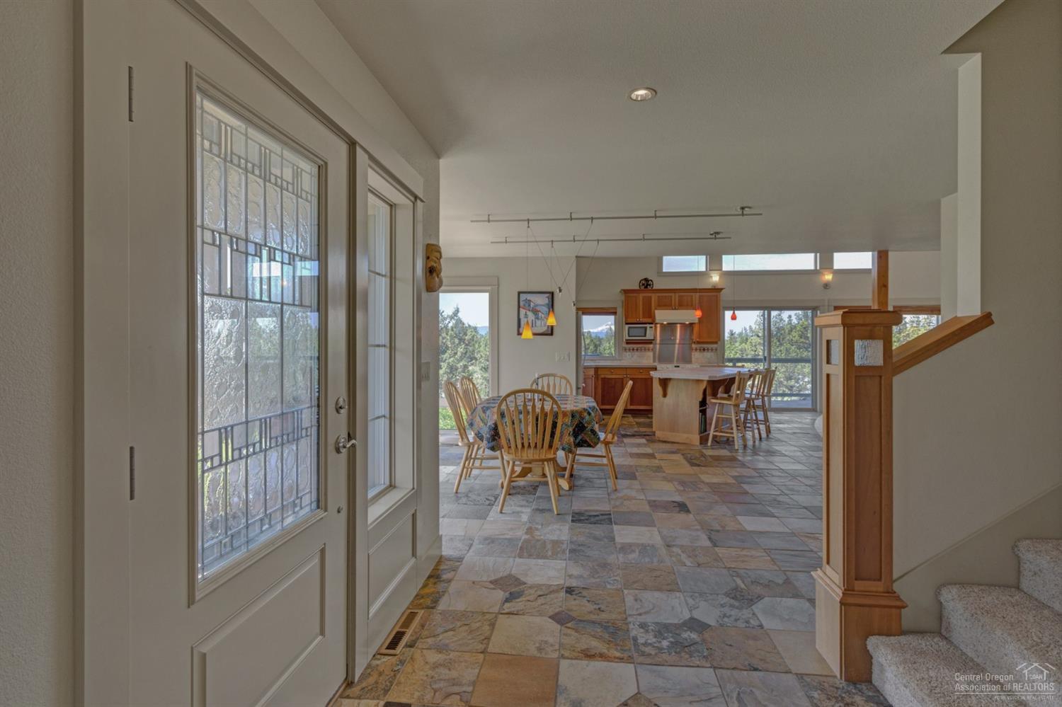 64405 Deschutes Market Road Bend, OR 97701 - Photo 3 of 25 a dining room with furniture and a glass door