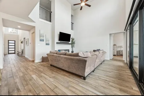 a living room with furniture and a flat screen tv