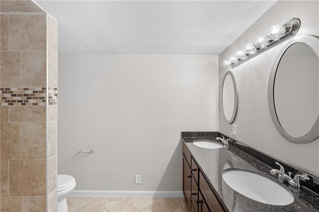 55 Wyman Street Southeast Atlanta, GA 30317 - Photo 19 of 25 a bathroom with a sink a toilet and a mirror