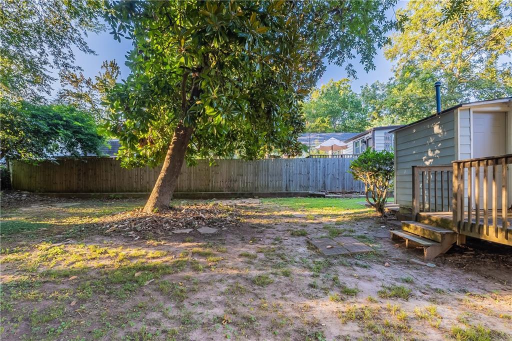 55 Wyman Street Southeast Atlanta, GA 30317 - Photo 22 of 25 a view of a backyard with a tree and wooden fence