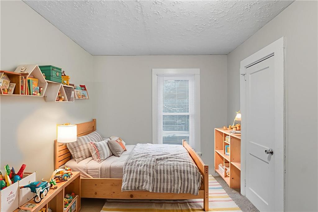 55 Wyman Street Southeast Atlanta, GA 30317 - Photo 4 of 25 a bedroom with a bed and a window