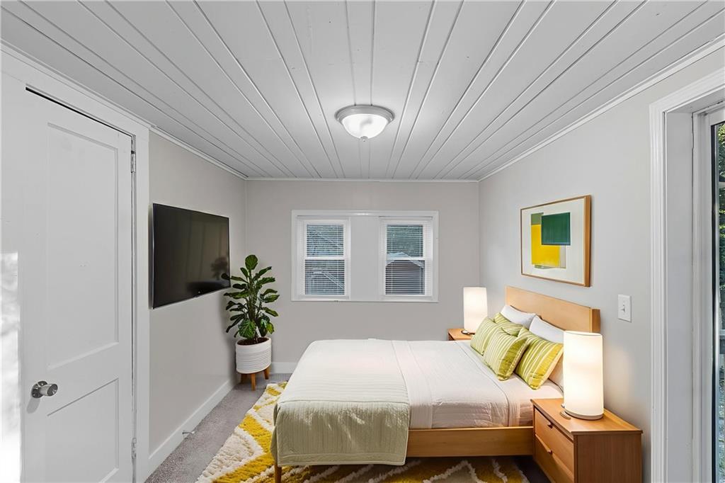 55 Wyman Street Southeast Atlanta, GA 30317 - Photo 5 of 25 a bedroom with a bed table and a window