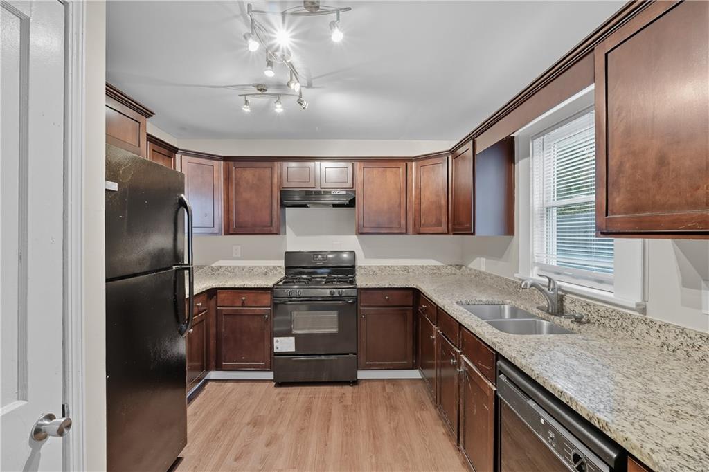 55 Wyman Street Southeast Atlanta, GA 30317 - Photo 6 of 25 a kitchen with stainless steel appliances granite countertop a sink stove and refrigerator